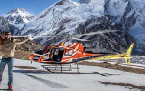 Helicopter in front of snowy mountain range